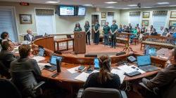 2024 student interns present their solutions to environmental and health risks and benefits of grass versus artificial turf to city officials in Verona